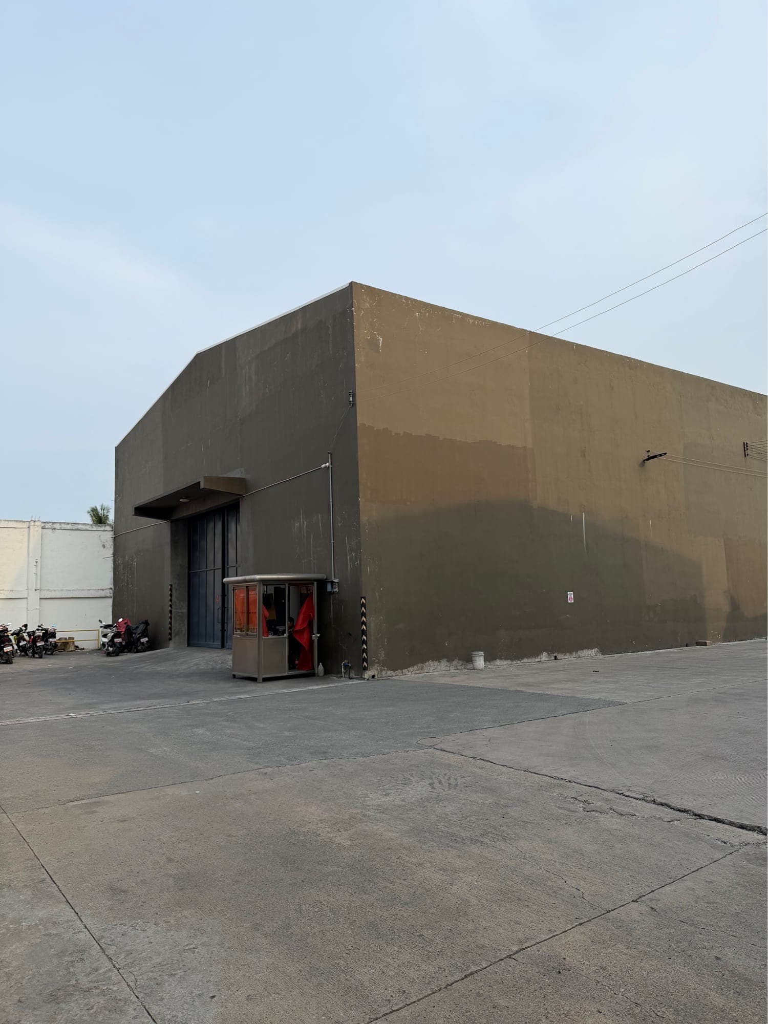 Side elevation of the warehouse showing the building depth and guarded entrance